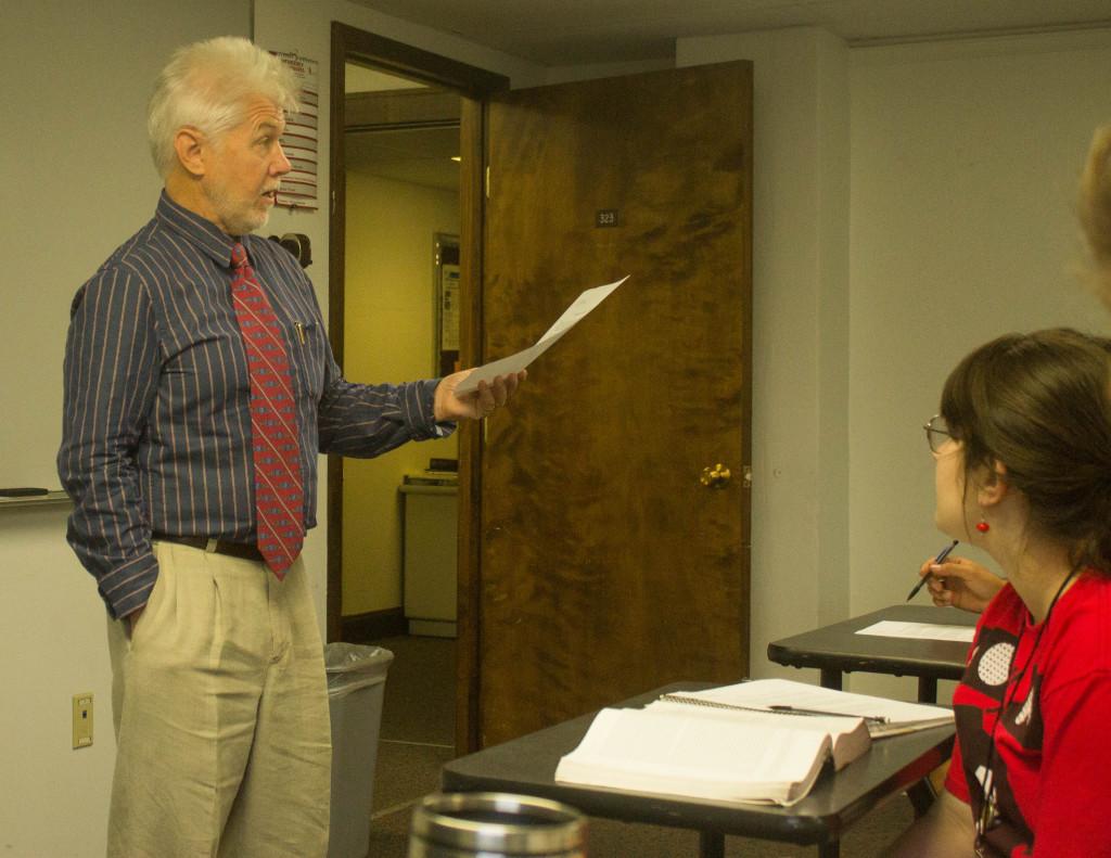 Dr. Dennis Okerstrom lectures his Early American Literature class, Junior Madison Butler is present. Okerstrom will publish his fifth book entitled Project 9 on March 2014