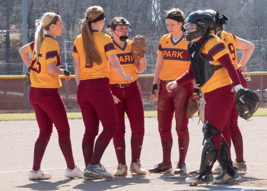 Park University huddle at the pitchers mound. Right to left Olivia Atkinson (Senior), Bailey Guiles (Senior), Shelby Bendure (Senior), Annali Cleek (Senior), Madison Klein (Junior), Katie Carr (Junior)