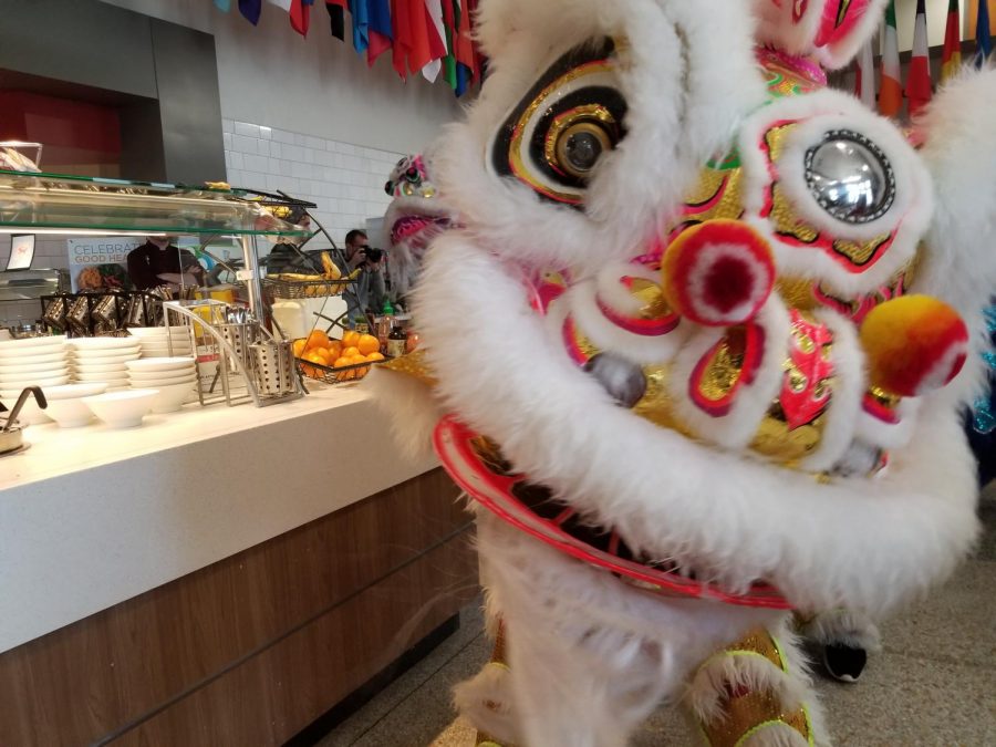 Pho Hien Troop's yellow lion dancing in the cafeteria at Park University