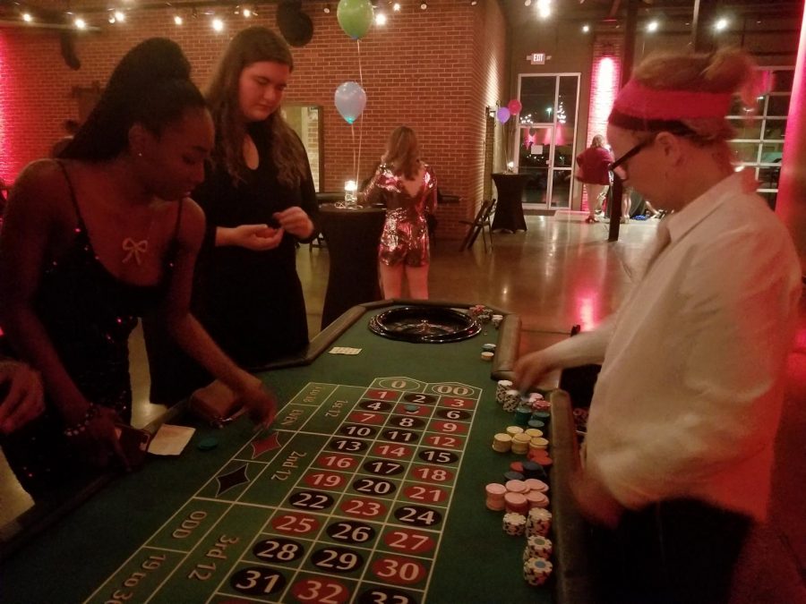 Students at the park university spring formal standing around a roulette table playing roulette