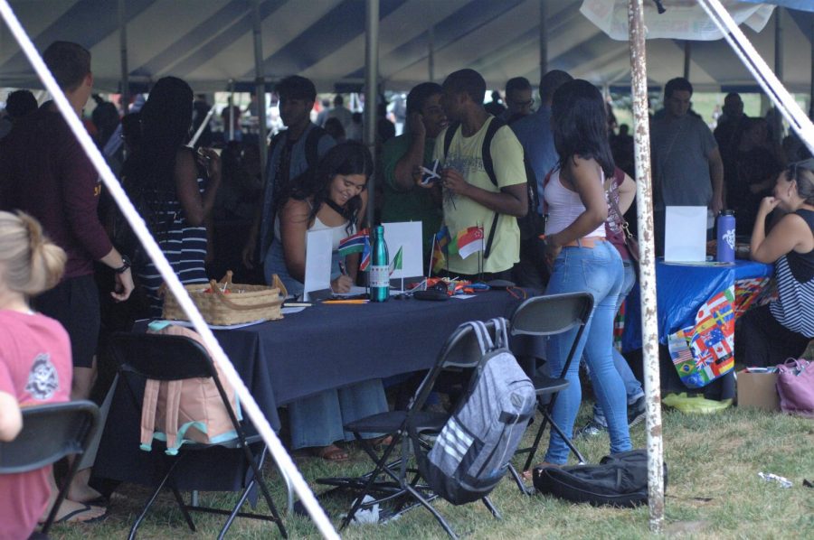 Zainab Abdulsalam helps a student sign up for the Park International club