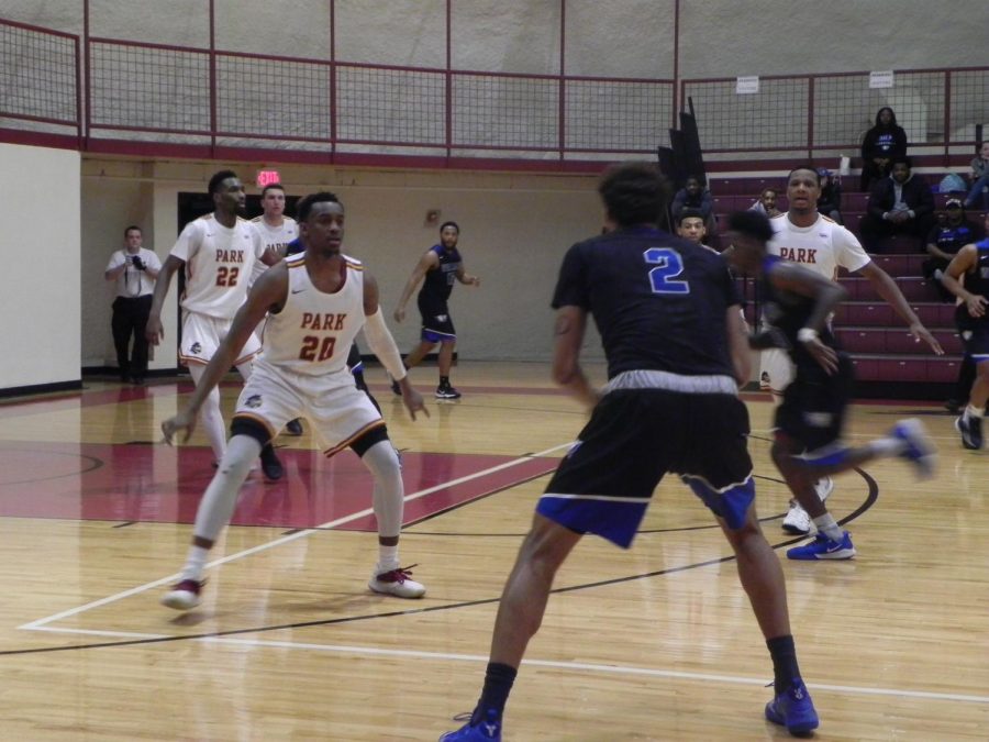 Senior guard Deionte Wilson defends against a Williams Baptist player with junior forward Ernest Myles III behind him. 