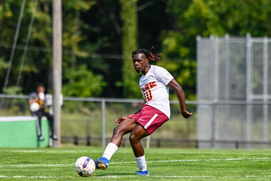 Rama Emeka Aniakor kicks the ball down Julian Field.