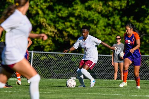 Senior Lenvix Ochieng kicks the ball down Julian Field.