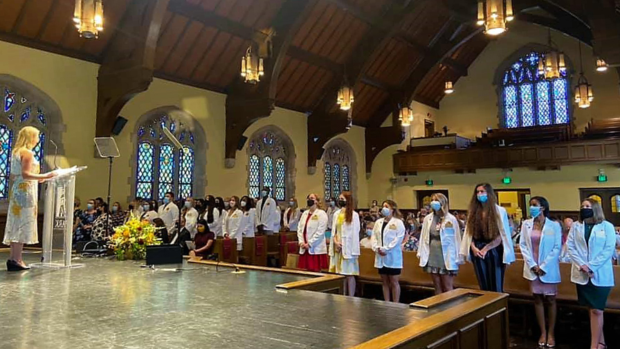 nursing students stand in Graham Tyler Memorial Chapel during their white coat ceremony