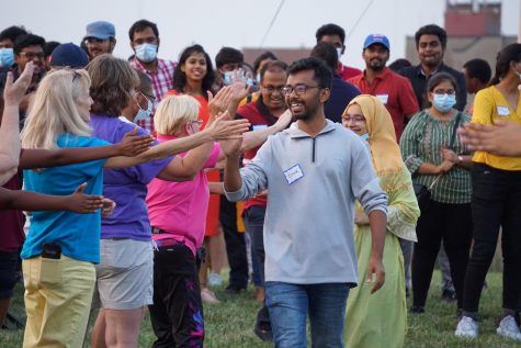 International students from India walk through the national parade as volunteer cheer them on.