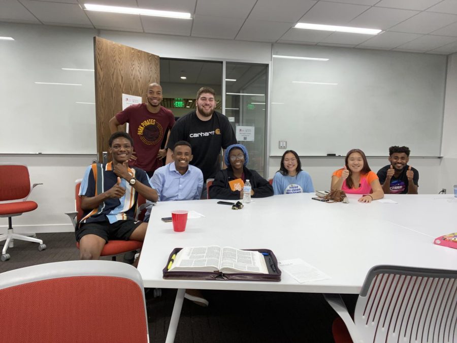 InterVarsity members posing for the camera in Norrington Library