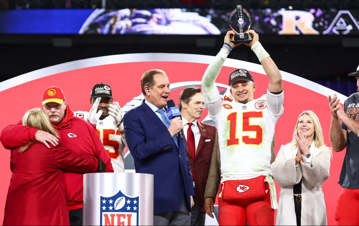 Quarterback Patrick Mahomes hoists the Lamar Hunt trophy after the AFC Championship win.