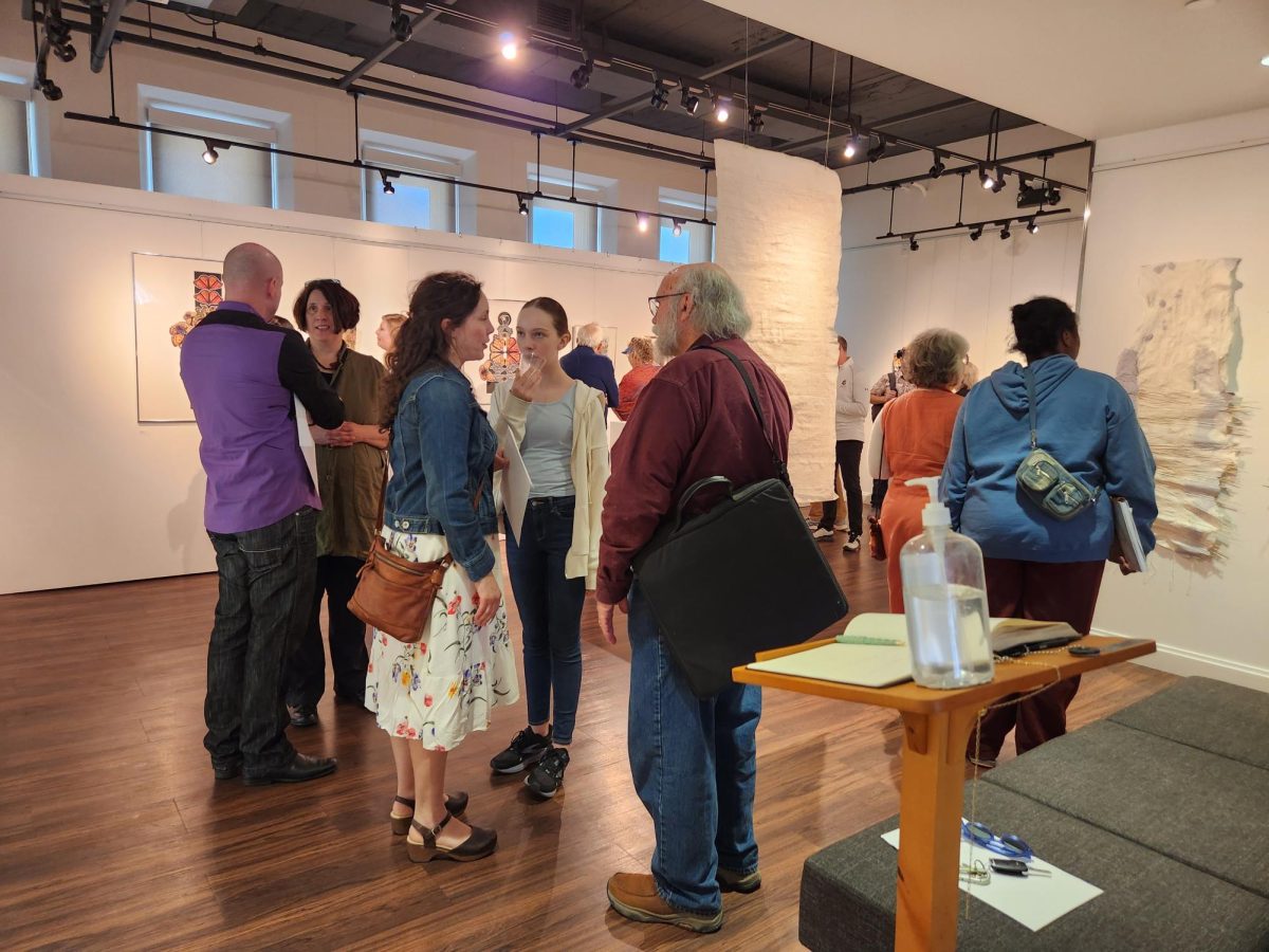 Viewers attend the opening of the gallery.